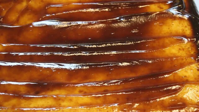 adding caramel for Tres leches cake, pan tres leches, a sponge cake soaked in three kinds of milk