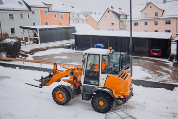 Compact loader on snowy worksite