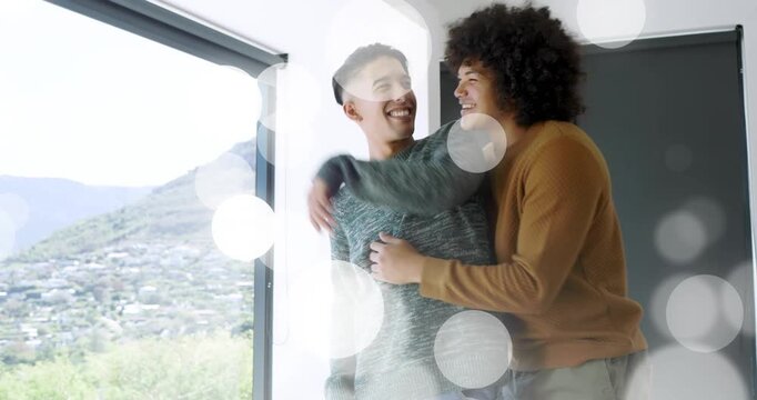 Two men by window, man entering placing hands leading pair embracing, home bokeh over valley frames