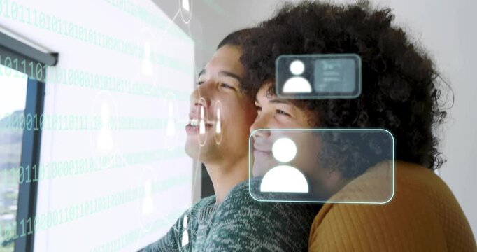Two men embracing at window, front man reaching, activating AR icons on glass, exploring social app
