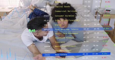 Two males scrolling phone and comparing laptop, activating animated finance charts tracking stocks