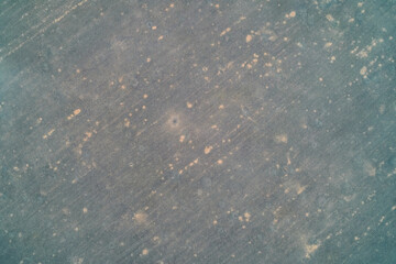 Dark field texture with numerous small light spots resembling shell scars. Abstract minimalist ground pattern - Aerial drone shot
