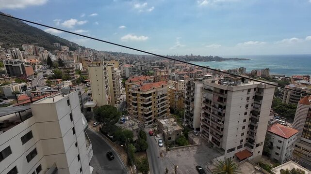 Aerial View of Coastal City with Sea in Background