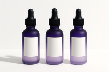 Three frosted purple glass dropper bottles with blank white labels and black pipette caps standing on a bright white surface, skincare serum packaging mockup