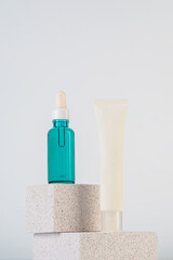 Cosmetic product in tube, bottle, lotion or serum with stylish props on white background. 