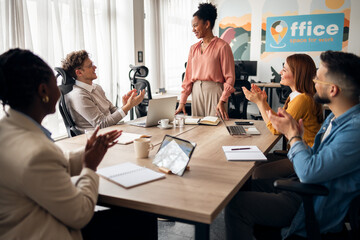 Diverse Team Celebrating Success During a Productive Office Meeting