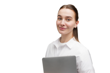 Person holds laptop and smiles in plain background