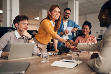 Office Team Engaged in Productive Business Meeting with Handshake