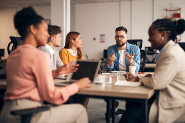 Diverse Team Collaborating During Business Meeting in Modern Office Setting