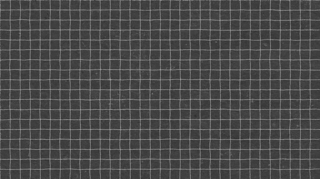 Detailed full frame view of a textured grid pattern on a dark gray surface background