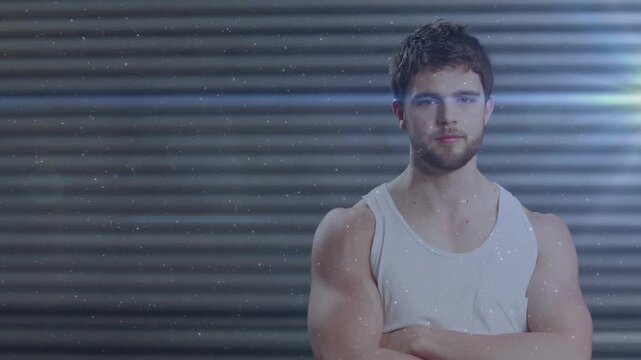 Fitness model arms crossed in studio offscreen cue shifting to smile while dust accenting promo