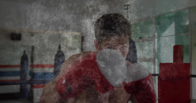Male boxer shifting weight and throwing punches with gloves for training, grime overlay animating