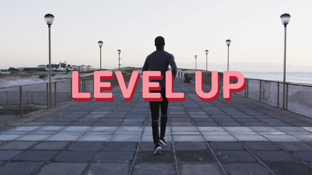 Man jogging coast while pink LEVEL UP graphic appearing causing 3D title over runner aiding fitness