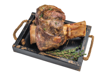 Slow cooked veal shank ossobuco style roasted with vegetables and gravy in baking tray on light background