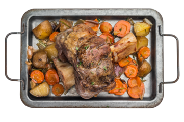 Italian veal osso buco slow cook shank with potatoes carrots herbs and broth in rustic roasting pan