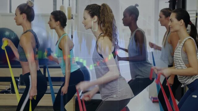 Six women on instructor cue, performing synchronized band squats on mats for fitness