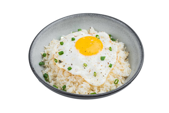 Crisp edged fried egg on soft steamed rice with sesame and pepper offering a rustic homemade breakfast full of warm flavors.