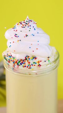 Colorful Sprinkles Falling Onto Tropical Pineapple Smoothie Dessert