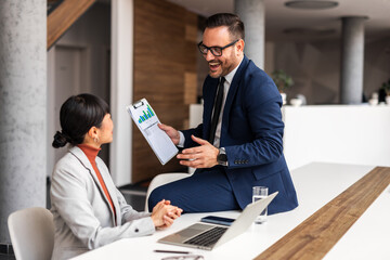 Professional Business Discussion Between Colleagues in Modern Office Setting