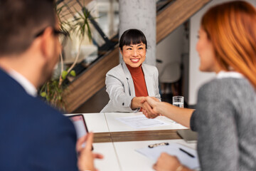 Businesswoman Shaking Hands with Employer During Office Interview