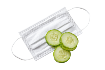 White disposable face mask with fresh green cucumber slices on black medical protection, Isolated On White Background, Png Transparent