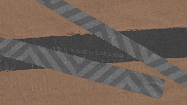 Textured paper composition with ruler marks and decorative striped grey tape overlapping brown and dark grey surfaces