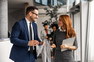 Professionals Collaborating and Smiling in a Bright Modern Office Environment
