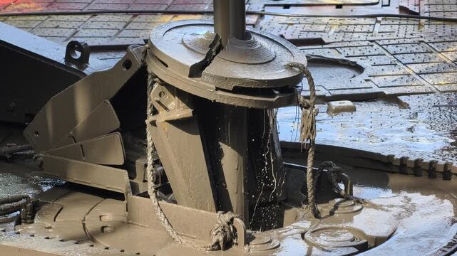 Drilling rig activity - Pull of of hole drill string with oil based mud on the rig floor.

