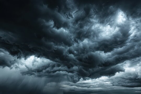 Dramatic storm cloudscape: dark thunderclouds roll across a gray sky