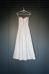 Elegant bridal gown, Sleek satin wedding dress on hanger showcase