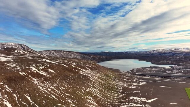 Aerial view of a scenery with partly snow covered mountains near Husavik - Iceland