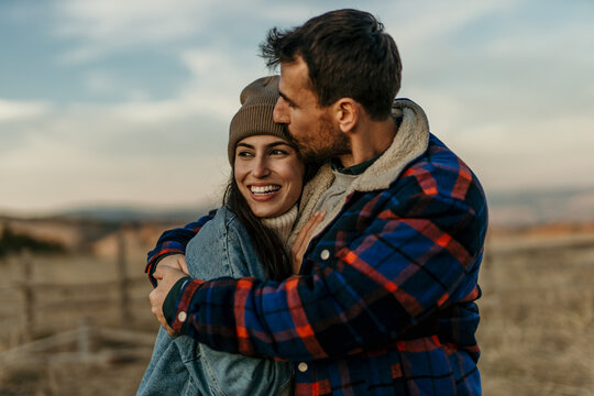 Loving couple embracing outdoors enjoying happy moment