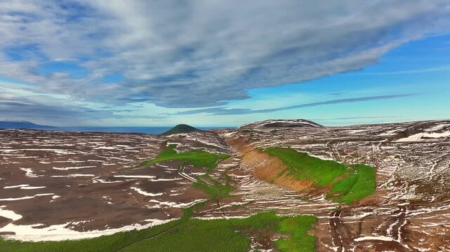Aerial view of a scenery with partly snow covered mountains near Husavik - Iceland
