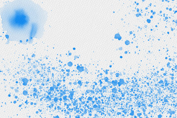 Blue watercolor splatter texture on paper creating an artistic abstract background design