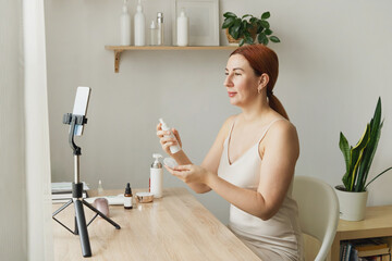 A beauty blogger records content for social media using a smartphone