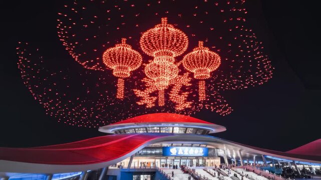 Drone Light Show Forms Chinese Lanterns Above Modern Building at Night