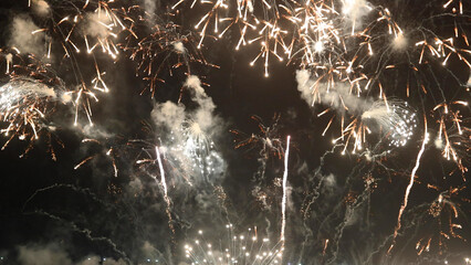 Amazing real beautiful colorful fireworks background on celebration night event for happy new year party, Abstract Multi color golden firework in the night sky