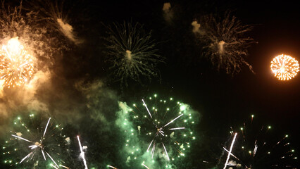 Amazing real beautiful colorful fireworks background on celebration night event for happy new year party, Abstract Multi color golden firework in the night sky