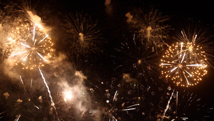 Amazing real beautiful colorful fireworks background on celebration night event for happy new year party, Abstract Multi color golden firework in the night sky