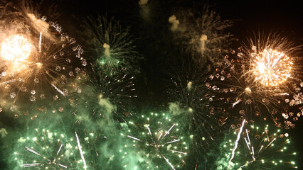 Amazing real beautiful colorful fireworks background on celebration night event for happy new year party, Abstract Multi color golden firework in the night sky