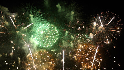 Amazing real beautiful colorful fireworks background on celebration night event for happy new year party, Abstract Multi color golden firework in the night sky