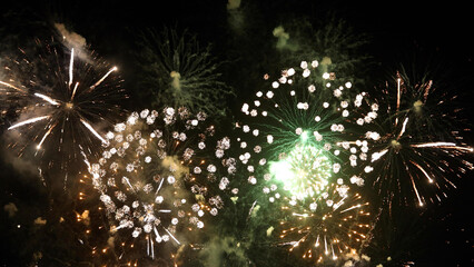 Amazing real beautiful colorful fireworks background on celebration night event for happy new year party, Abstract Multi color golden firework in the night sky