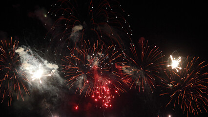 Amazing real beautiful colorful fireworks background on celebration night event for happy new year party, Abstract Multi color golden firework in the night sky