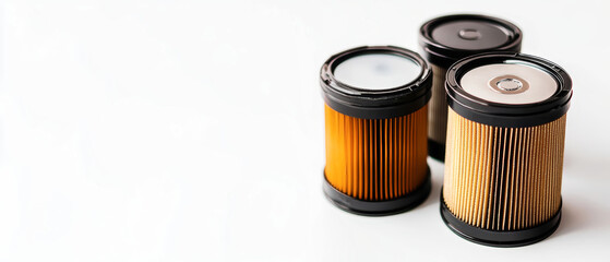 Three unique styles of car oil filters stand out with crisp details against a white backdrop, showcasing their design and quality in soft lighting