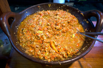 Sambal Bawang, spicy onion sauce, traditional chili sauce from Indonesia, on a clay pan