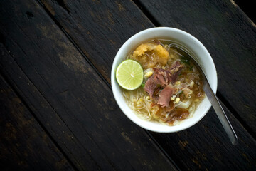 Soto Daging, a traditional Javanese, Indonesia beef soup with vegetables and rice
