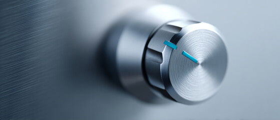 Close-up of a metallic control knob with blue indicator marks on a brushed metal surface, showcasing industrial design and precision engineering