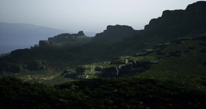 Rocky hills rise majestically under the dusk sky, surrounded by patches of lush greenery. The fading light highlights the contours of the landscape, creating a serene atmosphere.