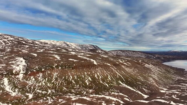Aerial view of a scenery with partly snow covered mountains near Husavik - Iceland