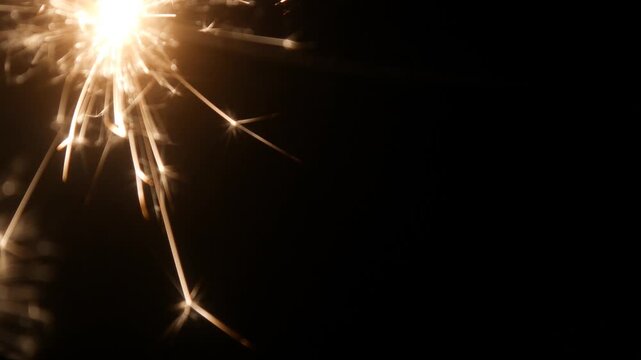 Children set off fireworks in the darkness of the night.